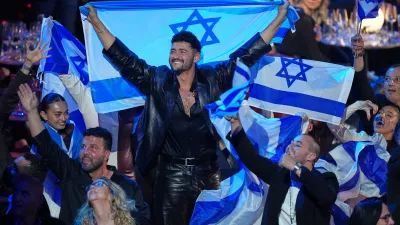 Noam Bettan from Israel, center, reacts as the points are awarded during the Grand Final of the 70th Eurovision Song Contest in Vienna, Austria, Sunday, May 17, 2026. (AP Photo/Martin Meissner)