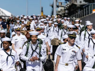 Sailors walk off of Pier 11 to find their loved ones after disembarking from the USS Gerald R. Ford at Naval Station Norfolk in Norfolk, Va. on Saturday, May 16, 2026, following an 11 month deployment. (Kendall Warner/The Virginian-Pilot via AP)