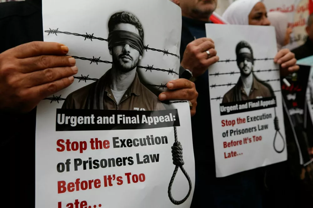 Palestinians take part in a protest against the Israeli death penalty law to be imposed on Palestinians convicted of deadly attacks, in Hebron, in the Israeli-occupied West Bank, April 2, 2026. REUTERS/Yosri Aljamal