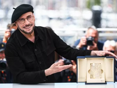 Director John Travolta poses with his Honorary Palm d'Or during a photocall for the film "Propeller One-Way Night Coach" (Vol de Nuit pour Los Angeles) presented as part of Cannes Premiere at the 79th Cannes Film Festival in Cannes, France, May 16, 2026. REUTERS/Manon Cruz