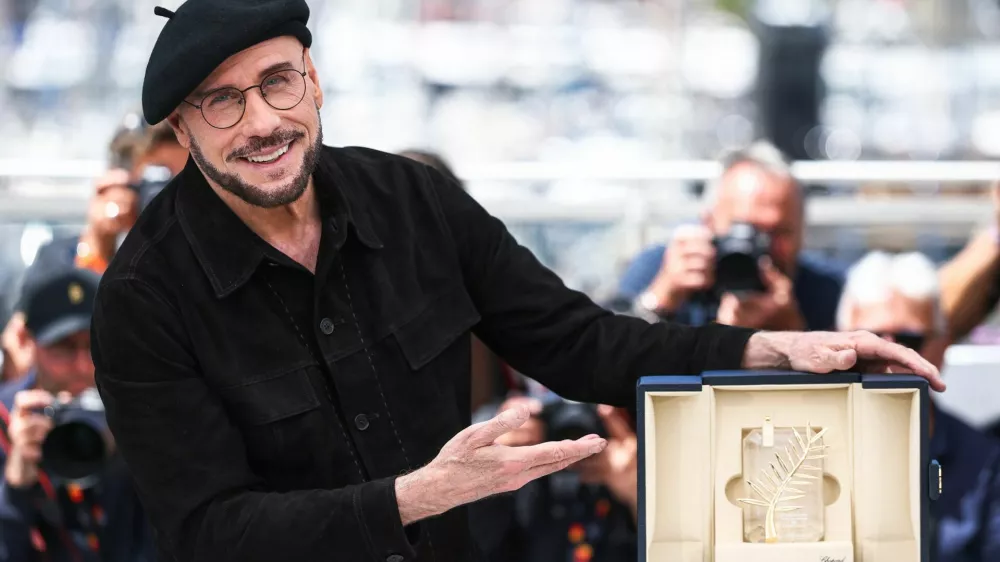 Director John Travolta poses with his Honorary Palm d'Or during a photocall for the film "Propeller One-Way Night Coach" (Vol de Nuit pour Los Angeles) presented as part of Cannes Premiere at the 79th Cannes Film Festival in Cannes, France, May 16, 2026. REUTERS/Manon Cruz