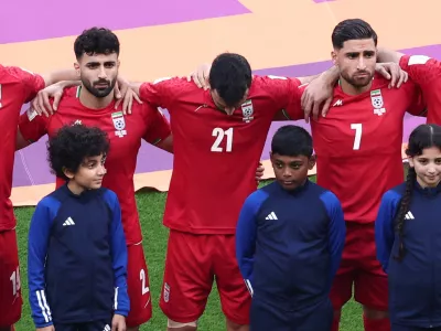 Soccer Football - FIFA World Cup Qatar 2022 - Group B - England v Iran - Khalifa International Stadium, Doha, Qatar - November 21, 2022 Iran's Ahmad Noorollahi, Sadegh Moharrami and Alireza Jahanbakhsh line up during the national anthems before the match REUTERS/Marko Djurica