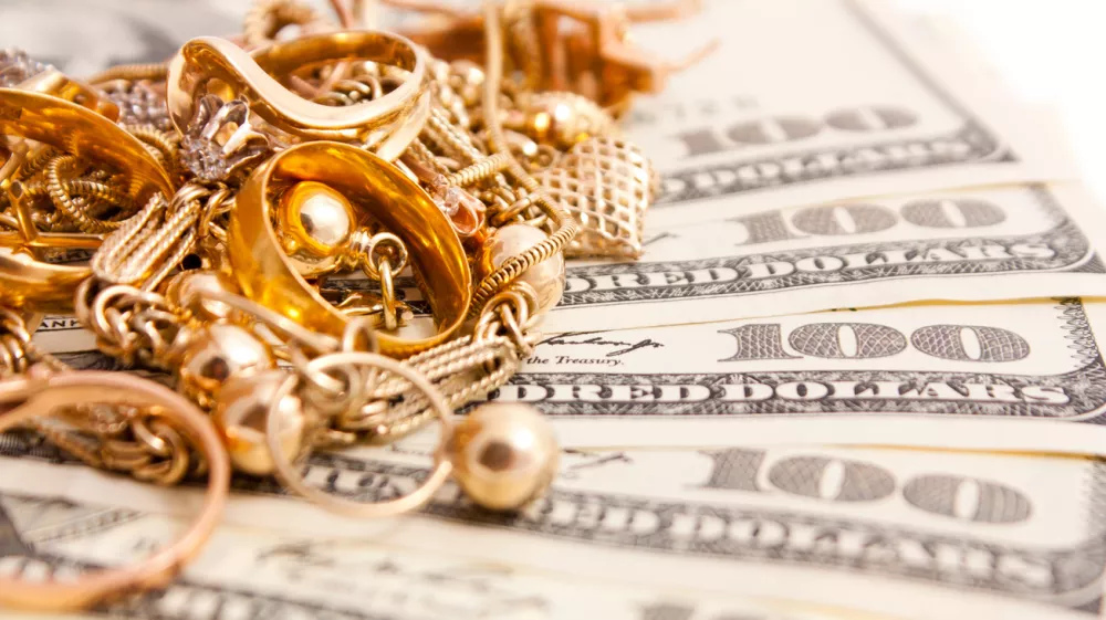 Closeup photo of jewelry on dollars. Isolated on white background.