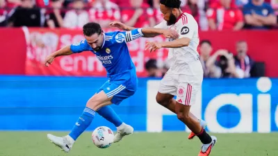 Real Madrid's Dani Carvajal, left, duels for the ball with Sevilla's Chidera Ejuke during the Spanish La Liga soccer match in Seville, Spain, Sunday, May 17, 2026. (AP Photo/Jose Breton)