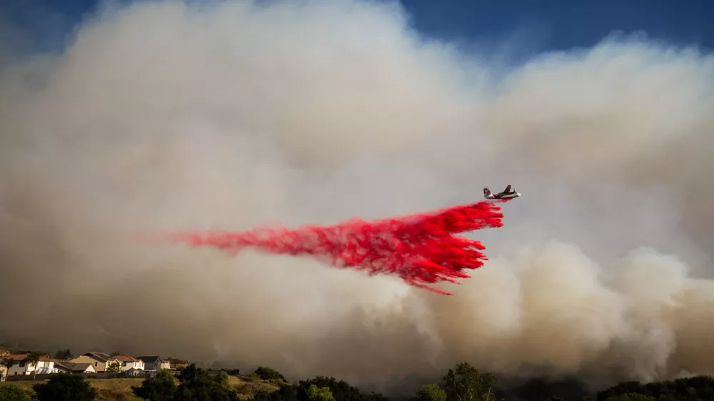 An air tanker drops retardant on the Sandy Fire on Monday, May 18, 2026, in Simi Valley, Calif. (AP Photo/Ethan Swope)