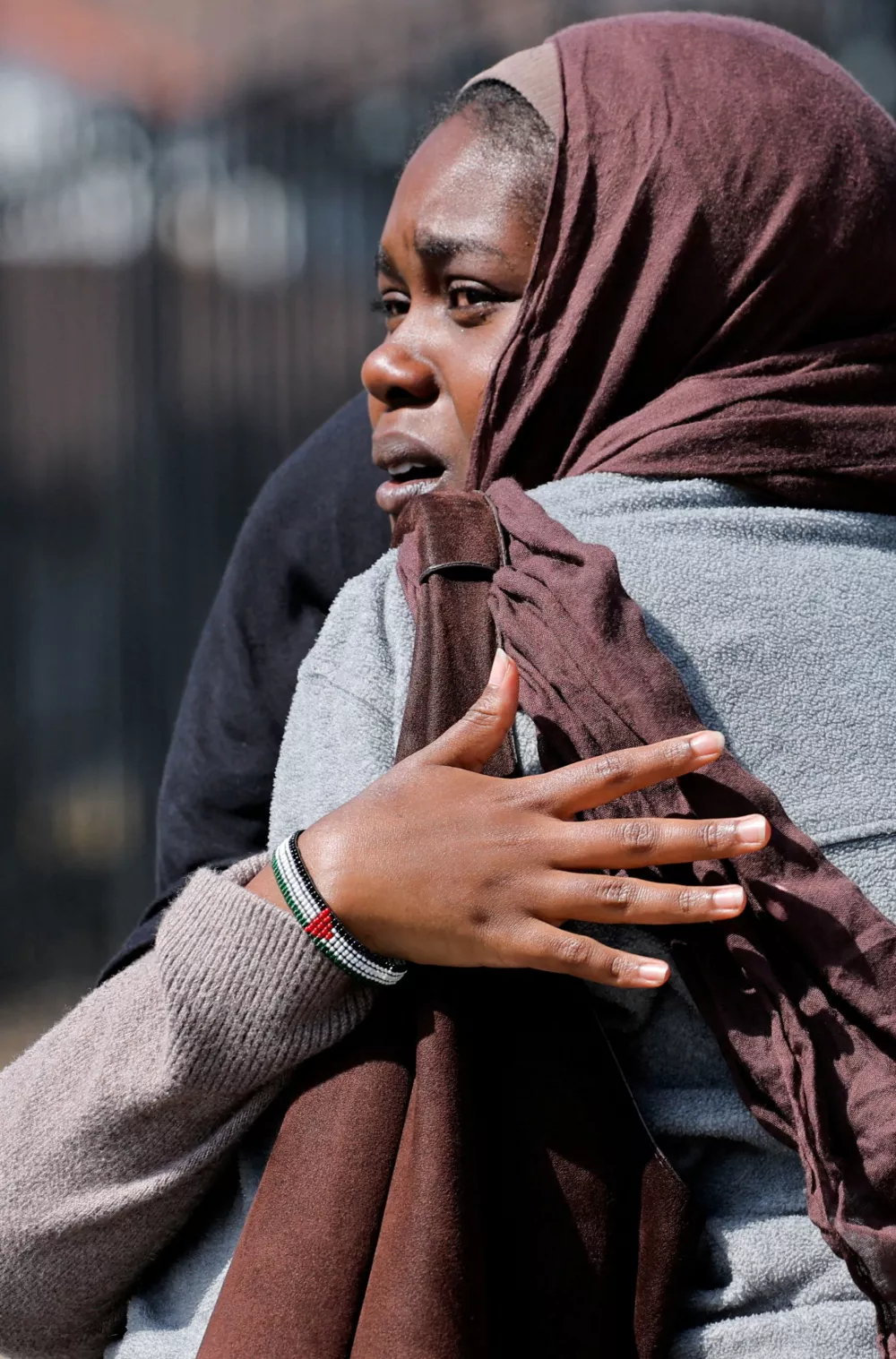 Women hug as they wait for the children to walk out of the mosque, at a collecting area, at the scene of a shooting at the Islamic Center in San Diego, California, U.S., May 18, 2026. REUTERS/Mike Blake