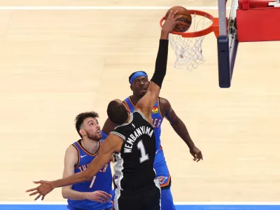 San Antonio Spurs forward Victor Wembanyama (1) shoots against Oklahoma City Thunder center Chet Holmgren (7) and guard Luguentz Dort during the second overtime of Game 1 in a third-round NBA basketball playoffs series Monday, May 18, 2026, in Oklahoma City. (AP Photo/Nate Billings)
