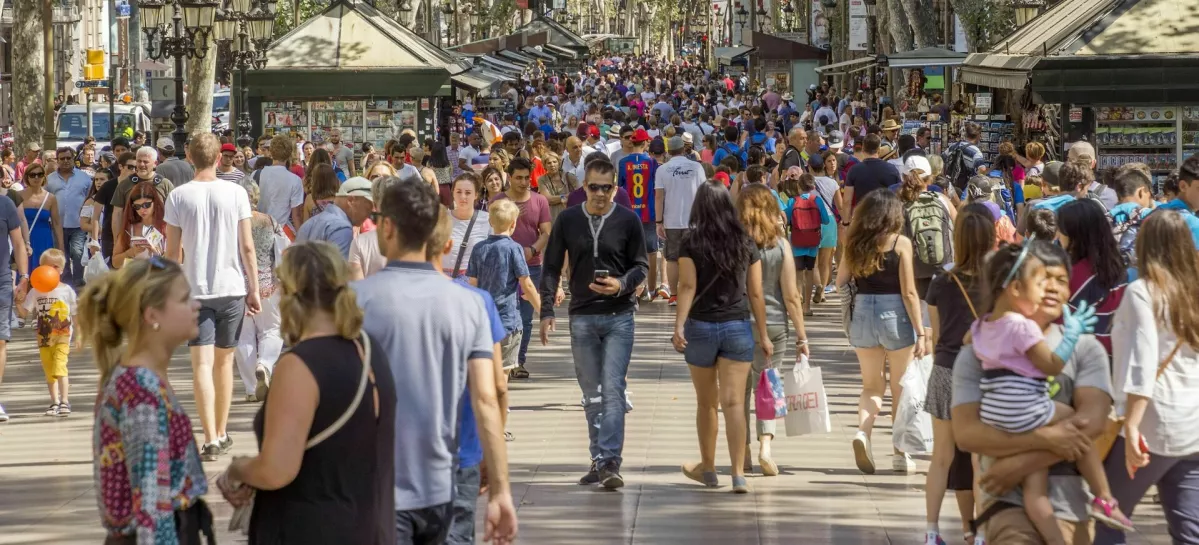 Barcelona, Spain - July 5, 2016: Hundreds of people promenading in the busiest street of Barcelona, the Ramblas. The street extends 1.2 kilometers connects the Placa de Catalunya in the centre with the Christopher Columbus Monument at Port Vell.
