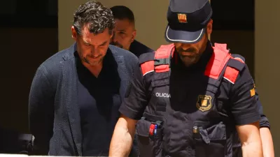 Jonathan Andic, the son of the founder of the Mango fashion group, Isak Andic, arrives at court escorted by police, where he is expected to be questioned after being detained in an investigation of the death of his father, who was killed in a fall from a cliff near Barcelona in December 2024, in Martorell, Spain, May 19, 2026. REUTERS/Albert Gea