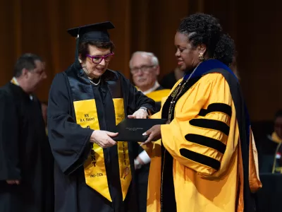 Tennis legend Billie Jean King, left, receives her diploma from California State University, Los Angeles, President Berenecea Johnson Eanes during commencement in Los Angeles, Monday, May 18, 2026. (AP Photo/Jae C. Hong)