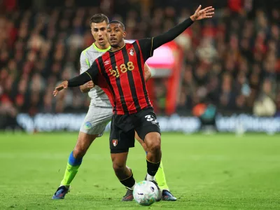 Manchester City's Rodrigo, left, challenges for the ball with Bournemouth's Rayan during the English Premier League soccer match between AFC Bournemouth and Manchester City in Bournemouth, England, Tuesday, May 19, 2026. (AP Photo/Ian Walton)