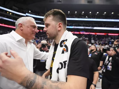 Los Angeles Lakers' Luka Doncic, right, hugs his father Sasa Doncic, left, following the team's NBA basketball game against the Dallas Mavericks in Dallas, Wednesday, April 9, 2025. (AP Photo/LM Otero)