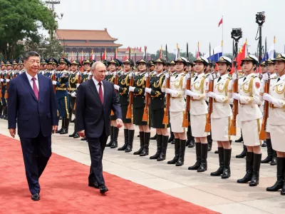 Russian President Vladimir Putin, right, and Chinese President Xi Jinping inspect an honor guard during a welcoming ceremony at the Great Hall of the People, in Beijing, China, on Wednesday, May 20, 2026. (Alexander Kazakov, Sputnik, Kremlin Pool Photo via AP)