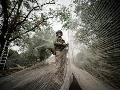 FILE PHOTO: A serviceman of the 24th Mechanized Brigade, named after King Danylo, of the Ukrainian Armed Forces installs anti-drone nets over a road, amid Russia's attack on Ukraine, in the frontline town of Kostiantynivka in Donetsk region, Ukraine September 19, 2025. Oleg Petrasiuk/Press Service of the 24th King Danylo Separate Mechanized Brigade of the Ukrainian Armed Forces/Handout via REUTERS ATTENTION EDITORS - THIS IMAGE HAS BEEN SUPPLIED BY A THIRD PARTY./File Photo