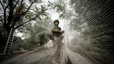 FILE PHOTO: A serviceman of the 24th Mechanized Brigade, named after King Danylo, of the Ukrainian Armed Forces installs anti-drone nets over a road, amid Russia's attack on Ukraine, in the frontline town of Kostiantynivka in Donetsk region, Ukraine September 19, 2025. Oleg Petrasiuk/Press Service of the 24th King Danylo Separate Mechanized Brigade of the Ukrainian Armed Forces/Handout via REUTERS ATTENTION EDITORS - THIS IMAGE HAS BEEN SUPPLIED BY A THIRD PARTY./File Photo