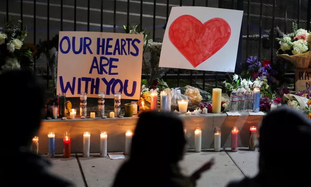 Candles and signs are placed on the ground as people pay their respects in front of the Islamic Center of San Diego after the vigil in a park, the day after a fatal shooting incident, in San Diego, California, U.S., May 19, 2026. REUTERS/Daniel Cole