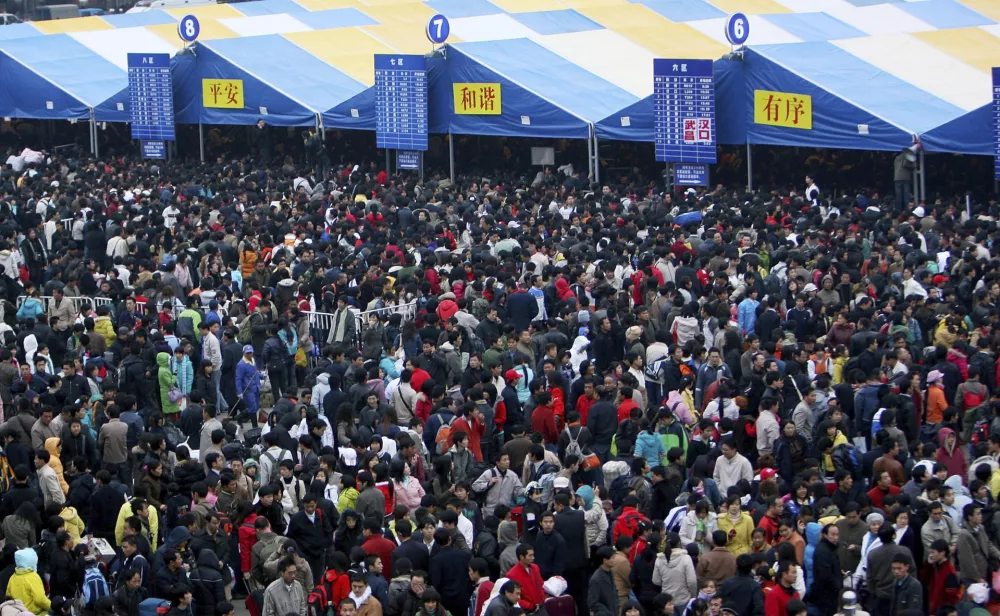 Passengers wait for their trains at Guangzhou Railway Station in Guangzhou, in south China's Guangdong province Sunday, Jan. 27, 2008. Some 100,000 passengers have been stranded at the station as trains are delayed by snow in other parts of the country. Forecasters warned of more snowstorms in central and eastern China, telling local governments to brace for further pressure on already severely strained transport, power and communications. (AP Photo/Color China Photo) ** CHINA OUT **