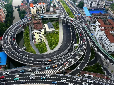Aerial view of the two "nail houses" encircled by an overpass connecting the Zhoutouzui Tunnel in Guangzhou city, south China's Guangdong province, 11 August 2015.Images of two residential buildings surrounded by an overpass have gone viral in China. The houses were set to be demolished to create space for a bridge which would connect an elevated expressway to a newly opened underground tunnel in Guangzhou, Guangdong Province, reported China News Service. While most of the residents accepted the relocation compensation, three families refused to move out of their homes. The construction workers had no other choice but to build an overpass around the lonely "nail houses". The company has promised to surround the buildings with a noise barrier to make things more tolerable for the residents. Officials added that if the families should choose to move out later on, they would still be offered relocation packages.