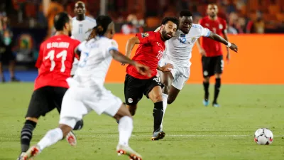 Soccer Football - Africa Cup of Nations 2019 - Group A - Egypt v DR Congo - Cairo International Stadium, Cairo, Egypt - June 26, 2019 DR Congo's Wilfred Moke in action with Egypt's Mohamed Salah     REUTERS/Mohamed Abd El Ghany