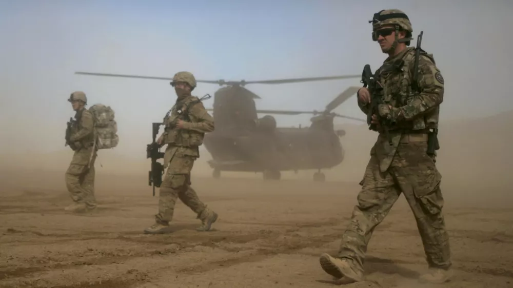 FILE - In this Jan. 28, 2012 file photo, U.S. soldiers, part of the NATO- led International Security Assistance Force (ISAF) patrol west of Kabul, Afghanistan. As the United States ends the nearly 20-year war in Afghanistan and as the Taliban recapture much of the country, Americans are asking if the longest war in their history was worth the cost. (AP Photo/Hoshang Hashimi, File)