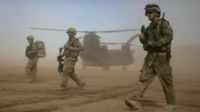 FILE - In this Jan. 28, 2012 file photo, U.S. soldiers, part of the NATO- led International Security Assistance Force (ISAF) patrol west of Kabul, Afghanistan. As the United States ends the nearly 20-year war in Afghanistan and as the Taliban recapture much of the country, Americans are asking if the longest war in their history was worth the cost. (AP Photo/Hoshang Hashimi, File)