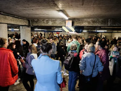People take shelter in an underground car park during an air raid alert in Vilnius, Lithuania, Wednesday, May 20, 2026. (Vygintas Skaraitis/Lrytas via AP)