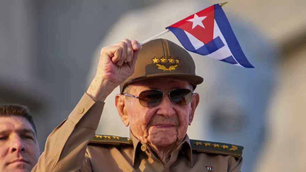 FILE - Raul Castro waves a Cuban national flag during a May Day parade at Revolution Square in Havana, May 1, 2025. (AP Photo/Ramon Espinosa, File)