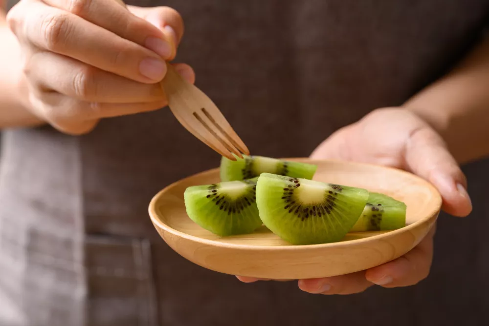 Sliced green kiwi fruit on wooden plate ready to eating, Healthy fruit