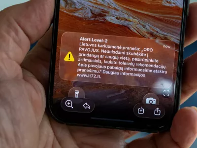The phone shows the received message "The Lithuanian military reports: "AIR DANGER. Hurry to cover or a safe place without delay, take care of your loved ones, wait for further recommendations. We will inform you about the end of the danger in a separate message", in Vilnius, Lithuania, Wednesday, May 20, 2026. (AP Photo/Mindaugas Kulbis)