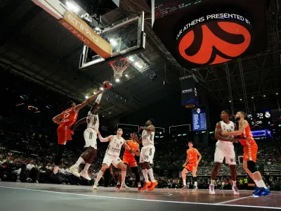 Valencia's Neal Sako, left, and Real Madrid's Usman Garuba battle for the ball near the basket during the Euroleague semifinal basketball match between Valencia and Real Madrid in Athens, Greece, Friday, May 22, 2026. (AP Photo/Thanassis Stavrakis)