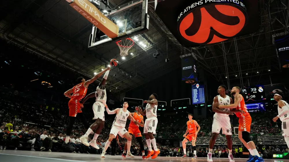 Valencia's Neal Sako, left, and Real Madrid's Usman Garuba battle for the ball near the basket during the Euroleague semifinal basketball match between Valencia and Real Madrid in Athens, Greece, Friday, May 22, 2026. (AP Photo/Thanassis Stavrakis)