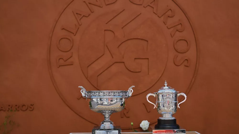 The men's, left, and women's trophies are displayed in-front of the Roland-Garros logo during qualifications for the French Open tennis tournament in Paris, Friday, May 22. (AP Photo/Emma Da Silva)