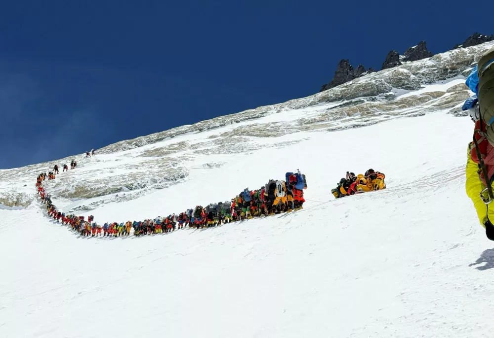Climbers walk in a long queue at yellow band as they head to ascend Mount Everest in the Solukhumbu district, also known as the Everest region, Nepal, May 19, 2026. REUTERS/Purnima Shrestha