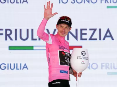 Denmark's Jonas Vingegaard wears the pink jersey of the race overall leader on the podium after winning the 14th stage of the Giro d'Italia cycling race, from Aosta to Pila, Italy, Saturday, May 23, 2026. (Gian Mattia d'Alberto /LaPresse via AP)