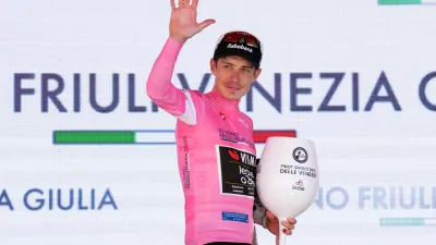 Denmark's Jonas Vingegaard wears the pink jersey of the race overall leader on the podium after winning the 14th stage of the Giro d'Italia cycling race, from Aosta to Pila, Italy, Saturday, May 23, 2026. (Gian Mattia d'Alberto /LaPresse via AP)
