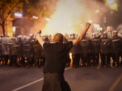 An anti-government protester taunts riot police during a rally led by Serbia's protesting university students who are pushing for major political changes in the Balkan country run by President Aleksandar Vucic, in Belgrade, Serbia, Saturday, May. 23, 2026. (AP Photo/Armin Durgut)