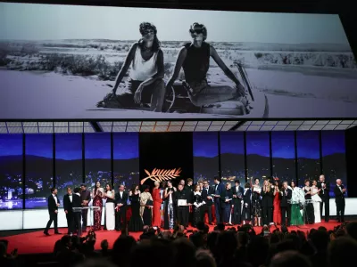 Director Marie-Clementine Dusabejambo, Camera d'Or award winner for the film "Ben'imana", director Cristian Mungiu, Palme d'Or award winner for the film "Fjord", Renate Reinsve, Sebastian Stan, Tilda Swinton, Isabelle Huppert, Emmanuel Macchia and Valentin Campagne, co-winners of the Best Actor award winner for their roles in the film "Coward", Isaach De Bankole, Jury member of the 79th Cannes Film Festival, directors Javier Ambrossi and Javier Calvo, co-winners of the Best Director award for the film "La bola negra" (The Black Ball), director Pawel Pawlikowski, co-winner of the Best Director award for the film "Fatherland", director Valeska Grisebach, Jury Prize award winner for the film "Das Getraumte Abenteuer" (The Dreamed Adventure - L'Aventure revee), director Andrey Zvyagintsev, Grand Prix award winner for the film "Minotaur" (Minotaure), Nadine Labaki, Virginie Efira and Tao Okamoto, Best Actress award co-winners for their roles in the film "Soudain" (All of a Sudden), pose on stage during the closing ceremony of the 79th Cannes Film Festival in Cannes, France, May 23, 2026. REUTERS/Sarah Meyssonnier
