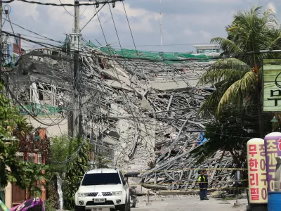 Caution tape marks the area around a collapsed building in Angeles city in Pampanga province, north of Manila, Philippines, Sunday May 24, 2026. (AP Photo)