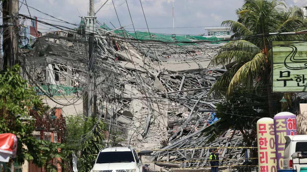 Caution tape marks the area around a collapsed building in Angeles city in Pampanga province, north of Manila, Philippines, Sunday May 24, 2026. (AP Photo)