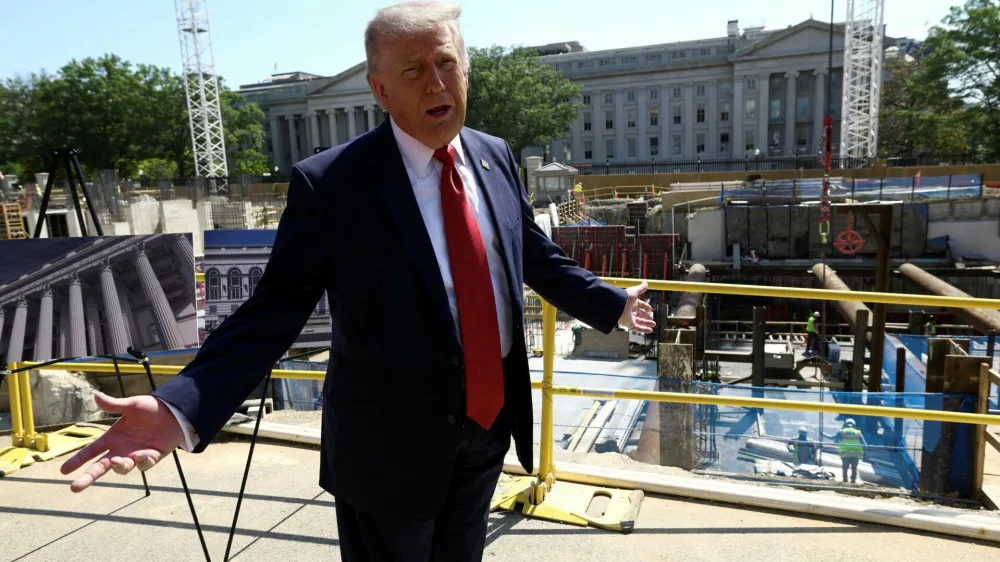 FILE PHOTO: U..S. President Donald Trump gestures at the site of ongoing construction of the planned White House ballroom in Washington, D.C., U.S., May 19, 2026. REUTERS/Kevin Lamarque