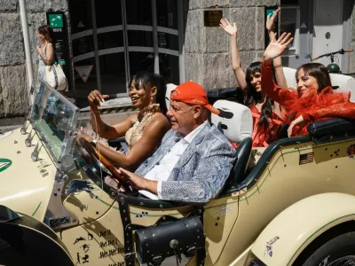 People wearing evening gowns ride a luxury convertible Excalibur Phaeton III car during the 79th Cannes Film Festival in Cannes, France, May 22, 2026. REUTERS/Marko Djurica