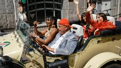 People wearing evening gowns ride a luxury convertible Excalibur Phaeton III car during the 79th Cannes Film Festival in Cannes, France, May 22, 2026. REUTERS/Marko Djurica