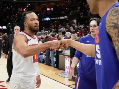 New York Knicks guard Jalen Brunson (11) celebrates with teammates after winning Game 3 in the Eastern Conference finals NBA basketball playoffs series against the Cleveland Cavaliers in Cleveland, Saturday, May 23, 2026. (AP Photo/Sue Ogrocki)