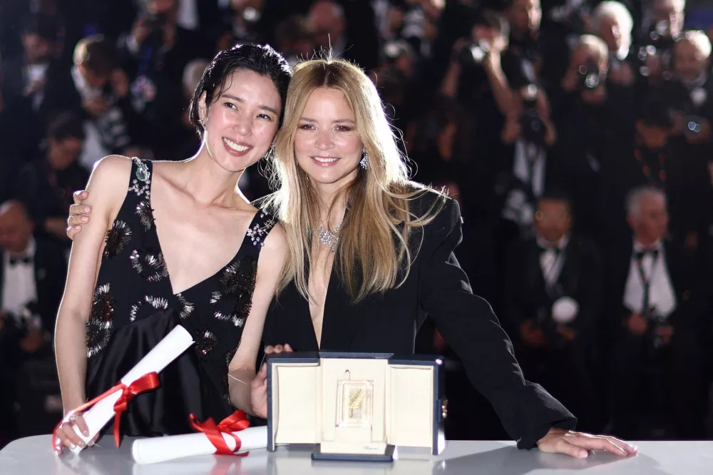 Virginie Efira and Tao Okamoto, Best Actress award co-winners for their roles in the film "Soudain" (All of a Sudden), pose during a photocall after the closing ceremony of the 79th Cannes Film Festival in Cannes, France, May 23, 2026. REUTERS/Gonzalo Fuentes   TPX IMAGES OF THE DAY