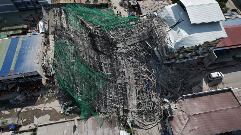 A collapsed building where multiple people are believed to be trapped in Angeles city in Pampanga province, north of Manila, Philippines Sunday, May 24, 2026. (AP Photo/Aaron Favila)