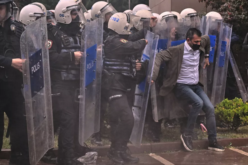 Police officers storm Turkey's main opposition Republican People's Party (CHP) headquarters to evict supporters gathered inside for party leader Ozgur Ozel, in Ankara, Sunday, May 24, 2026. (AP Photo/Ali Unal)