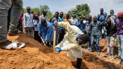 Red Cross workers bury an Ebola victim at the Rwampara Cemetery, in Rwampara, Congo, Saturday, May 23, 2026. (AP Photo/Moses Sawasawa) CORRECTION: City corrected to Rwampara, instead of Bunia