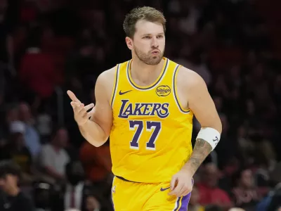 Los Angeles Lakers guard Luka Doncic (77) reacts after scoring during the second half of an NBA basketball game against the Miami Heat, Thursday, March 19, 2026, in Miami. (AP Photo/Lynne Sladky)