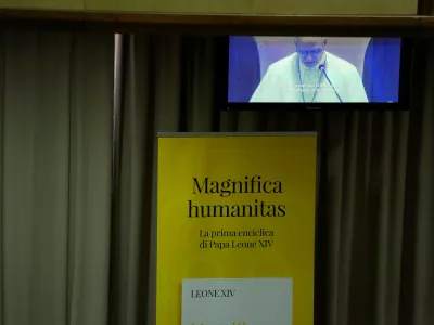 Pope Leo XIV, left, attends the presentation of his first encyclical, "Magnifica humanitas: On Safeguarding the Human Person in the Time of Artificial Intelligence," at the Vatican, Monday, May 25, 2026. (AP Photo/Alessandra Tarantino)
