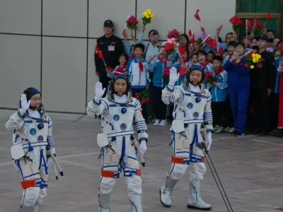 Astronaut for the Shenzhou 23 manned mission from left Hong Kong's Lai Ka-ying, identified by Chinese authorities as Li Jiaying using the Mandarin transliteration of the name, China's Zhu Yangzhu and Zhang Zhiyuan wave as they attend a see-off ceremony for their manned space mission at the Jiuquan Satellite Launch Center in northwestern China, Sunday, May 24, 2026. (AP Photo/Ng Han Guan)